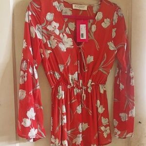 Never-worn long sleeve romper with tags.